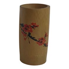 a wooden vase with red flowers painted on it