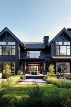 a large black house with lots of windows on the front and side of it's roof