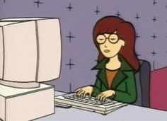 a woman sitting in front of a computer keyboard