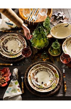 the table is set with dishes and place settings