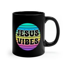 a black coffee mug with the words jesus vibes in rainbow colors and an egg on it