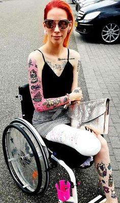 a woman with red hair sitting in a wheel chair