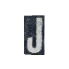 the letter u is made up of black and white paper with some type of paint