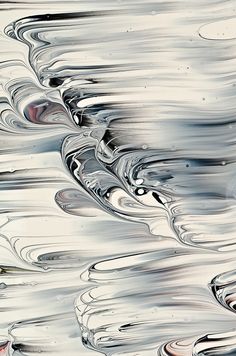 an abstract photo of water with ripples and reflections on the surface in grey tones