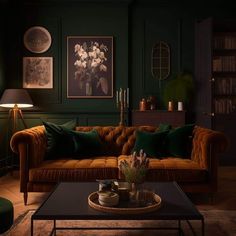 a living room with green walls and furniture in the corner, including a brown couch