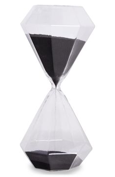 an hourglass sitting on top of a white table