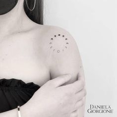 a woman's shoulder with small dots on the left side of her arm and chest