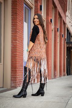 Western Tooled Fringe Vest Women's tooled print vest with fringe and studs. The perfect addition to your western style wardrobe. Model is wearing a size small 95% Polyester/5% Spandex Size Guide: Women's body measurements (inches) Sizes Small 6-8 Med 10-12 Large 14 XL-1X 16-18 2X 20-22 3X 24 Bust 35-36" 37-38.5" 40" 41.5-45" 47-49" 51" Waist 29.5-31" 32.5-34" 35" 37-39" 41.5-42" 44" Hips 36-36.5" 37.5-38" 40" 42-45" 45.5-46.5" 48" Brown Fringe Vest For Festival, Fitted Vest For Western-themed Events In Fall, Hippie Style Vest For Fall Festival, Festival Fringe Brown Vest, Bohemian Fringe Vest For Festivals, Sleeveless Vest For Fall Festival, Fall Festival Vest With Fringe, Brown Fringe Vest For Fall, Bohemian Brown Vest With Fringe