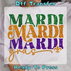 a woman wearing a mardi gras shirt with the words ready to press on it