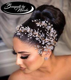 a woman wearing a bridal headpiece with flowers and leaves on it's side