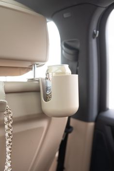 the interior of a car with a cell phone hanging from it's side window