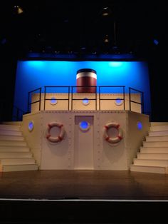 an empty stage with steps leading up to it and a life preserver in the center