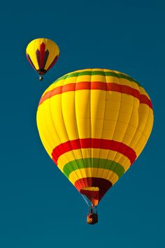 two hot air balloons flying in the sky