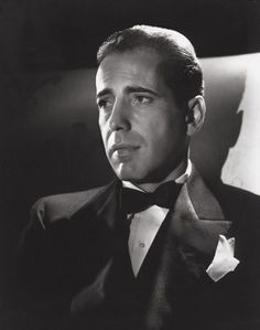 a black and white photo of a man in a tuxedo