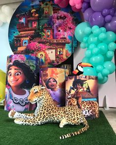 a birthday party with balloons and decorations including a cheetah statue, balloon garlands and an animal figurine