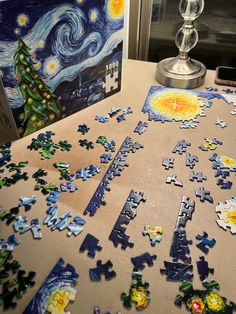 a table topped with lots of puzzle pieces