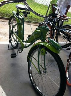 two green bicycles parked next to each other