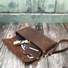 a brown leather bag with scissors and cards in it