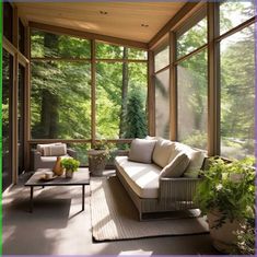 a living room filled with furniture and lots of windows on top of a wooden floor