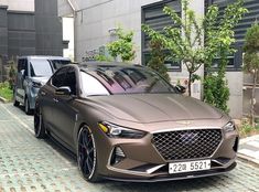 two cars parked next to each other in front of a building