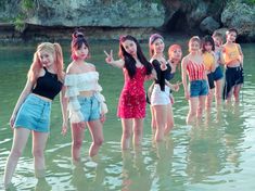 the girls are standing in the water together