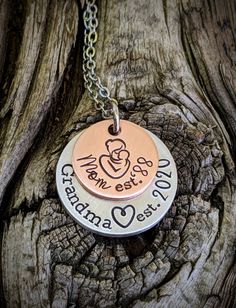 "Personalized hand stamped grandma necklace. Gift for grandma. Custom mothers day gift for grandma. Nana necklace. Memaw gift. First time grandma gift. Pregnancy announcment to mom. Custom pregnant announcement. Hand stamped and made to order. Made from a 5/8\" copper disc, stamped with a mama and baby stamp and stamped with the phrase, \"Mom est. (year of your choice),\" then a 7/8\" aluminum disc, stamped with the phrase, \"grandma est. (year of your choice).\" Stacked together and attached to Adjustable Hand Stamped Necklaces For Father's Day, Hand Stamped Round Necklaces For Mother's Day, Mother's Day Hand Stamped Necklace Gift, Hand Stamped Round Necklace For Mother's Day, Adjustable Hand Stamped Necklaces For Anniversary Gift, Adjustable Hand-stamped Necklaces For Anniversary Gift, Meaningful Hand Stamped Necklace For Mom, Birthday Jewelry For Mother's Day, Mother's Day Stamped Jewelry Gift For Mom