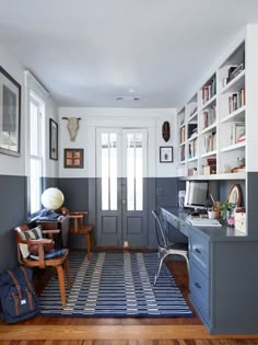 a home office with blue and white striped carpet, built - in bookshelves