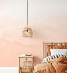 a bedroom with a pink wall and bed