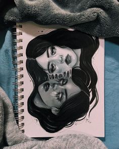 an image of a woman's face on top of a spiral notebook with skulls