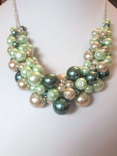 "This lovely Dark Green, Mint and Tan multi-color glass pearl cluster necklace will add the finishing touch to any outfit from casual to elegant.  This is a very gorgeous and fun necklace.   This necklace is adjustable in length from 15\" up to 20\".  Pearls are dark green, mint green and tan in various sizes from 6mm to 25mm.   Each pearl was hand wired to the adjustable length silver plated curb chain.  This is finished with a lobster claw closure.   Shipping to the US is flat rate priority mail small box. For international shipping, Please email for charges and shipping options before you check-out.  Price shown below is for international priority mail flat rate shipping.  Prices vary widely depending on methods. Thank You for looking! SRAJD = Self-Representing Artist in Jewelry Design" Peals Necklace, Pearl Cluster Necklace, Chunky Choker, Diy Gemstone, Soft Autumn, Green Mint, Pearl Cluster, Cluster Necklace, Necklace Wedding