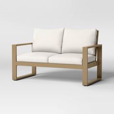 a white couch sitting on top of a wooden frame