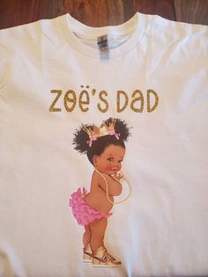 African American baby girl Pink and Gold T-shirt Great for baby shower or birthday party. T-shirt color can be white or pink Lettering can be gold, pink or white. T-shirts are 100% cotton. Processing Time: Please allow 5-7 business days for your order to be processed before shipping. Shipping: Please allow 3-5 business days for your order to be shipped. Personalized Pink T-shirt For Gender Reveal, Cute Pink Party T-shirt, Cute First Birthday T-shirt With Custom Print, Pink Crew Neck T-shirt For First Birthday, Cute Custom Print T-shirt For First Birthday, Personalized Pink T-shirt For Birthday, Pink And Gold Baby Shower, Birthday Party Pink, Baby Shower Shirts