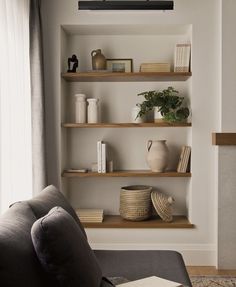 a living room filled with furniture and shelves