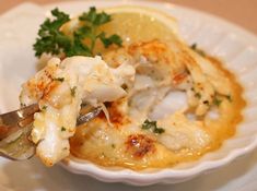 a white bowl filled with food and garnished with parsley