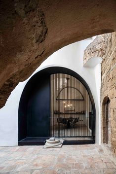 an arched doorway leads into a dining area