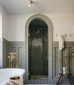 a white bath tub sitting next to a walk in shower