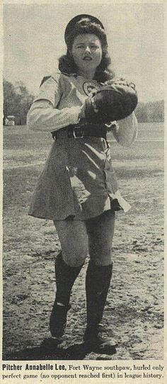 an old photo of a woman in uniform holding a baseball glove and wearing knee high boots