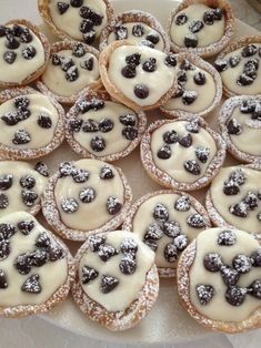 there are many small cookies with blueberries on them in the plate and one has chocolate chips