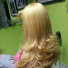 the back of a woman's head with long blonde hair