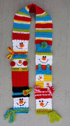 a crocheted snowman scarf is on display