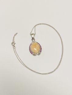 "Beautiful Sterling Silver Peach Agate w/ Amethyst Stone Pendant Necklace. This necklace is 18 inches in length; pendant measures 1 1/2 inches in length and 3/4 inch in width; weighs a total of 6 grams. The necklace is tested and stamped sterling silver; is also stamped \"BS inside a circle\". This pre-owned necklace is in good condition and is ready to be worn! Willing to answer any questions and send more pictures if requested, please feel free to ask! Please come check out other stunning uniq Amber Pendant Necklace With Cabochon, Amber Oval Necklace With Large Pendant, Amber Necklace With Large Oval Pendant, Amber Cabochon Oval Pendant Necklace, Oval Amethyst Cabochon Necklace, Amber Cabochon Round Pendant Necklace, Amethyst Cabochon Necklace For Gift, Hallmarked Amethyst Pendant Necklace, Pink Amethyst Pendant Necklace