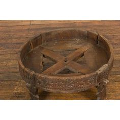 an old wooden tray with metal handles on a wood floor, showing the cross section