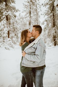 a man and woman kissing in the snow