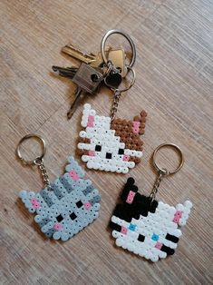 three keychains made to look like cartoon characters