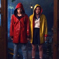 two people in raincoats standing next to each other