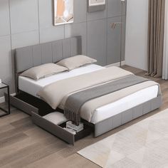 a white bed sitting on top of a wooden floor