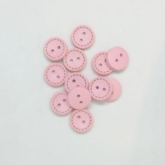 pink leather buttons on white background