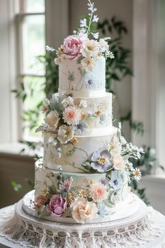 a three tiered cake with flowers on it