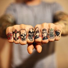 a person with many tattoos on their fingers