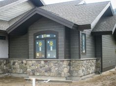 a large house with stone and wood siding